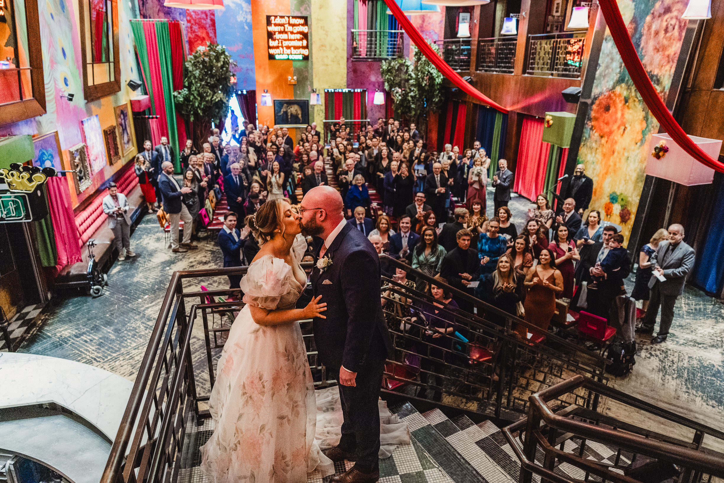 Newly married couple in front of a festive group at Carnivale